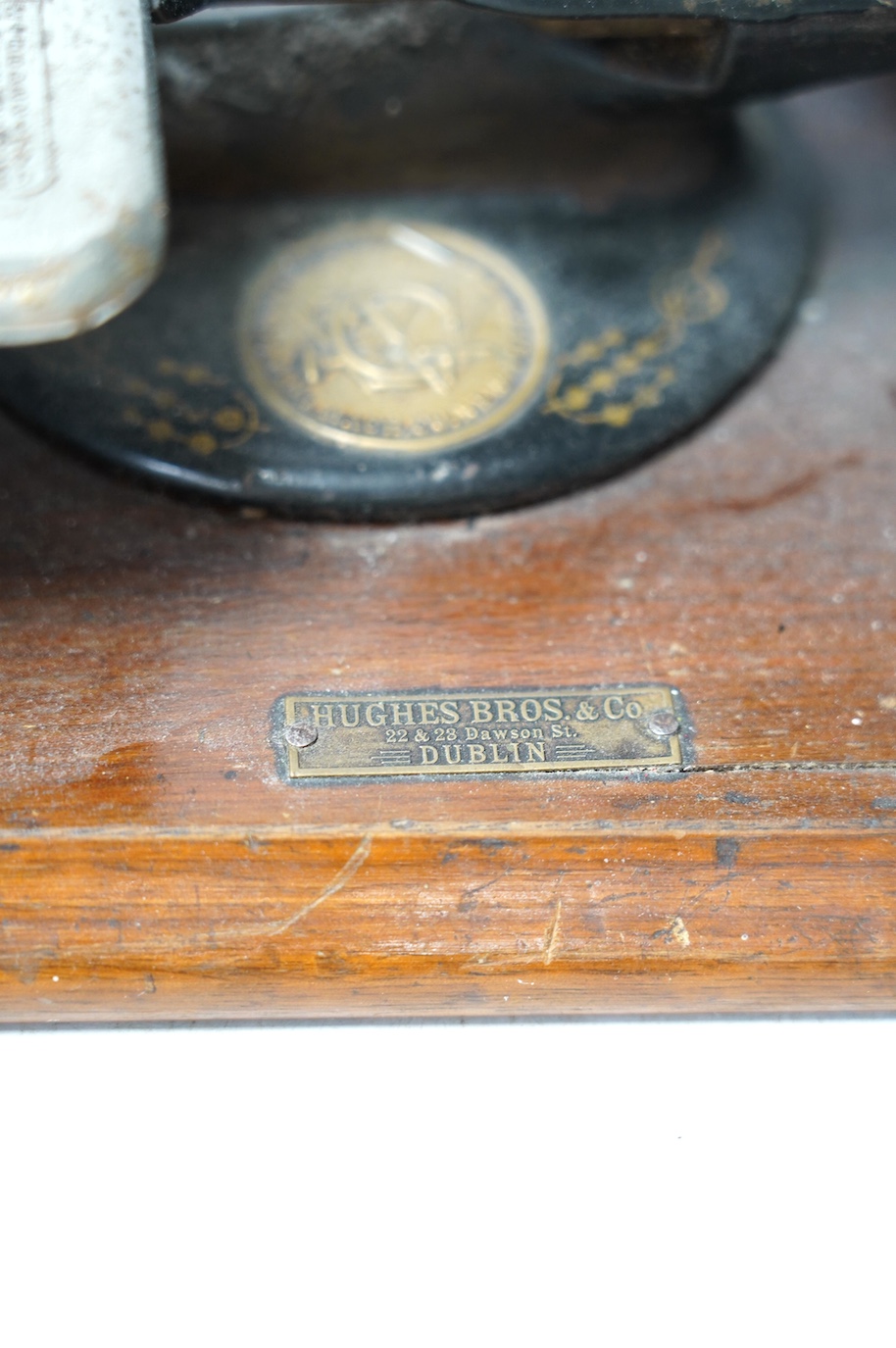 A late 19th century Wilcox and Gibbs sewing machine on a mahogany base. Condition - fair